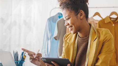 Woman working with laptop and tablet.