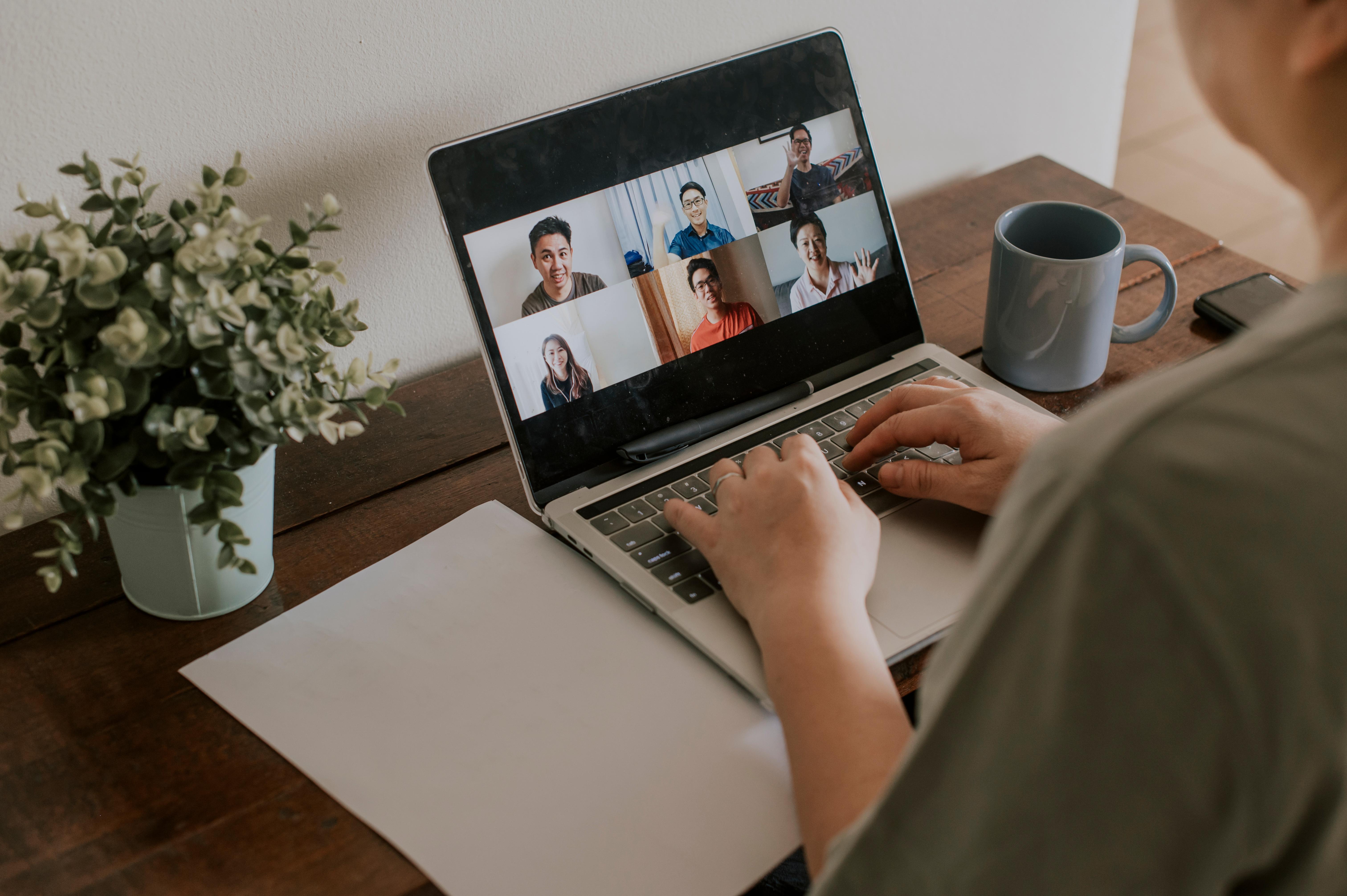 person with a macbook in a online meeting
