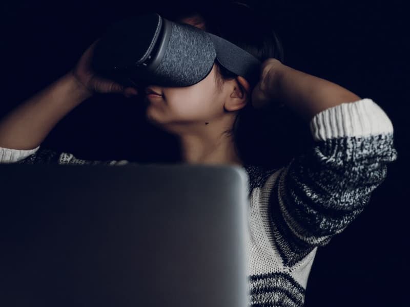 woman sitting in an office wearing vr glasses