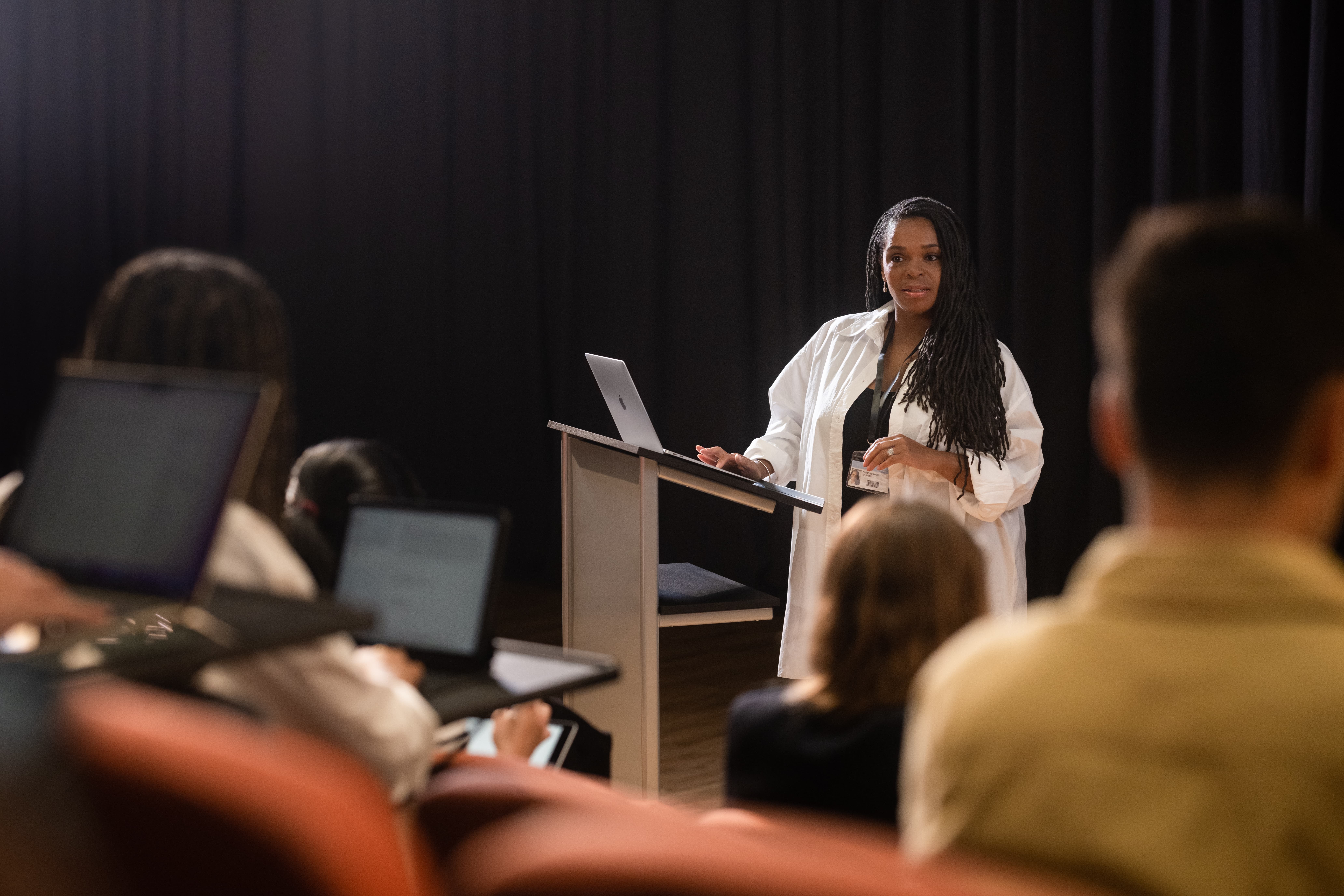 female teacher holding a lecture in class room