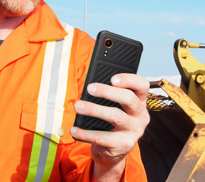 person in orange vest using a samsung phone