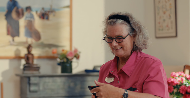 A caregiver woman using a phone
