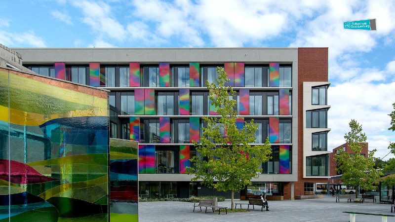 High-rise building with colourful glass panels